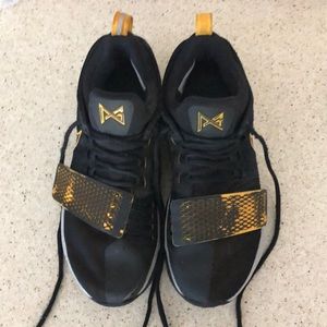 PG 1s basketball shoes “ black gold colorway”.